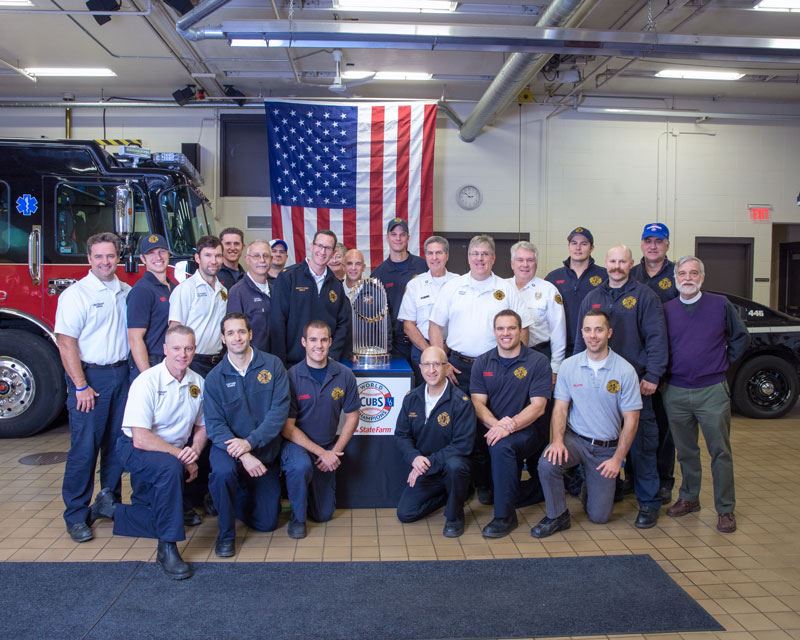 fire department posing with the world series trophy
